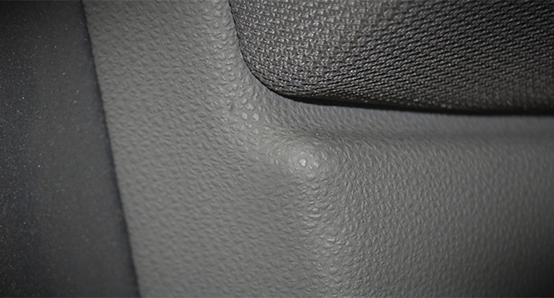 After image of vinyl repair on grey car interior.