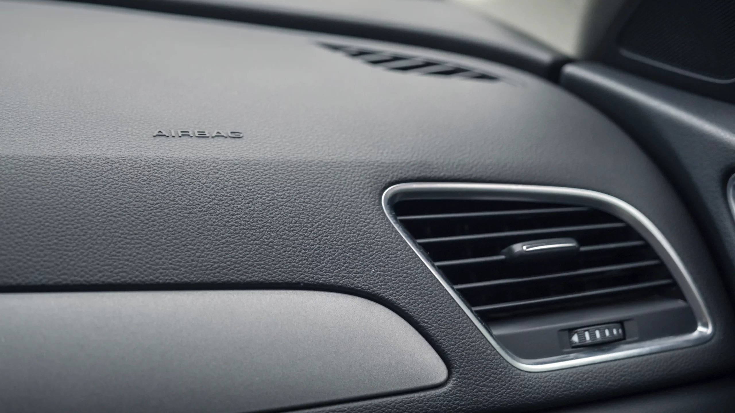 Closeup of a cosmetic damage on a car dashboard after repair.