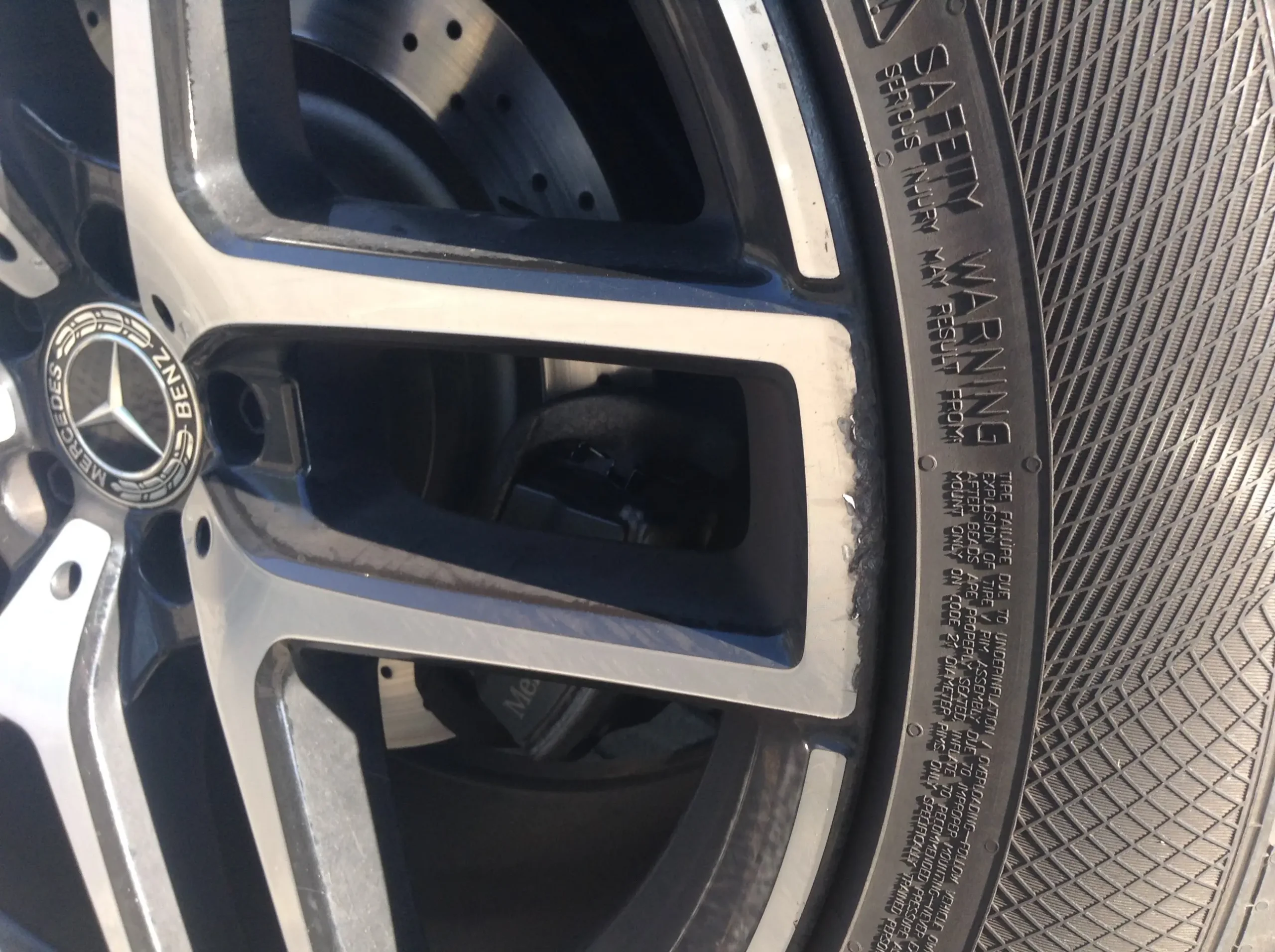 Diamond Cut alloy wheel with tire, which has curb damage and scratches