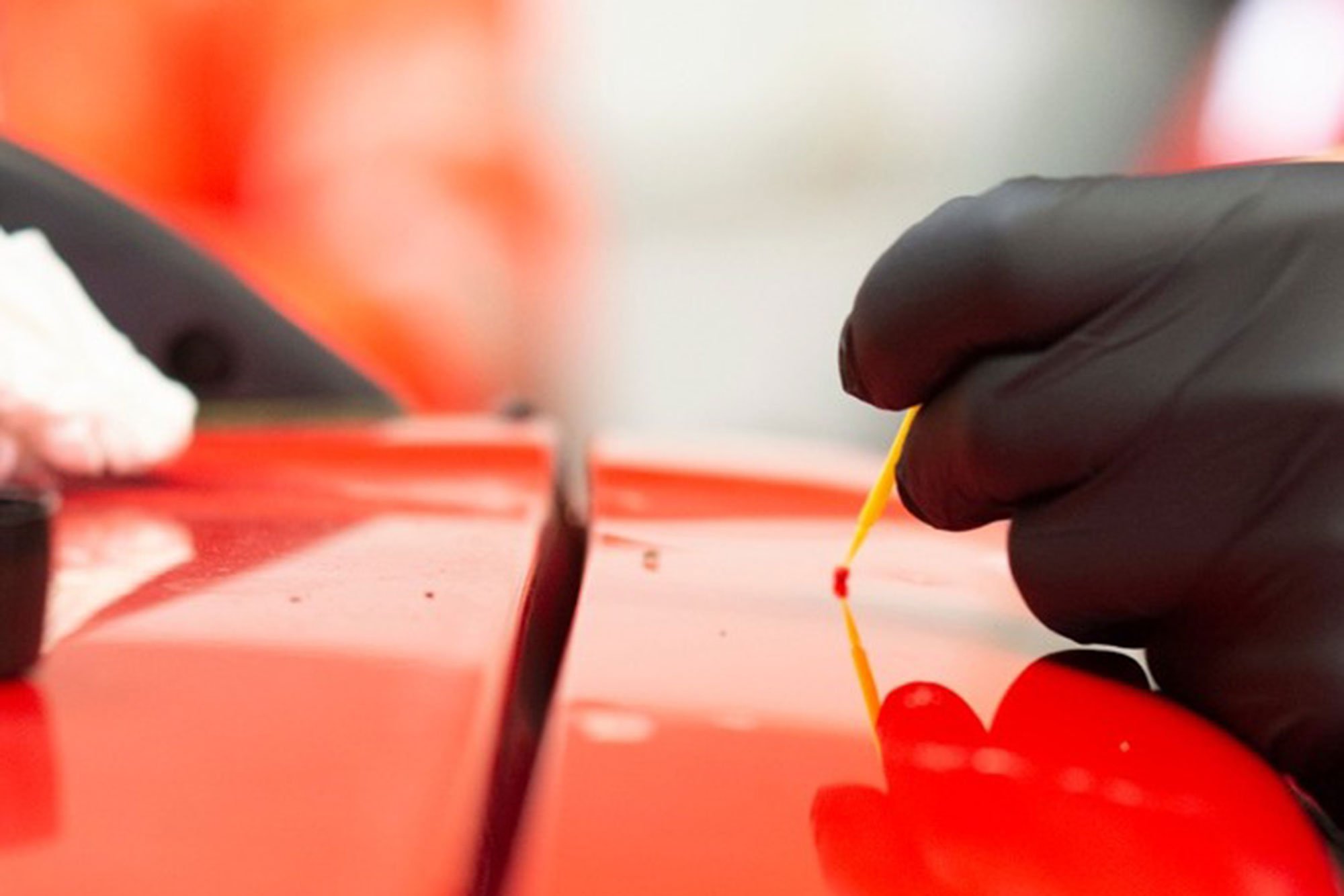 Car with a glossy finish in a workshop.