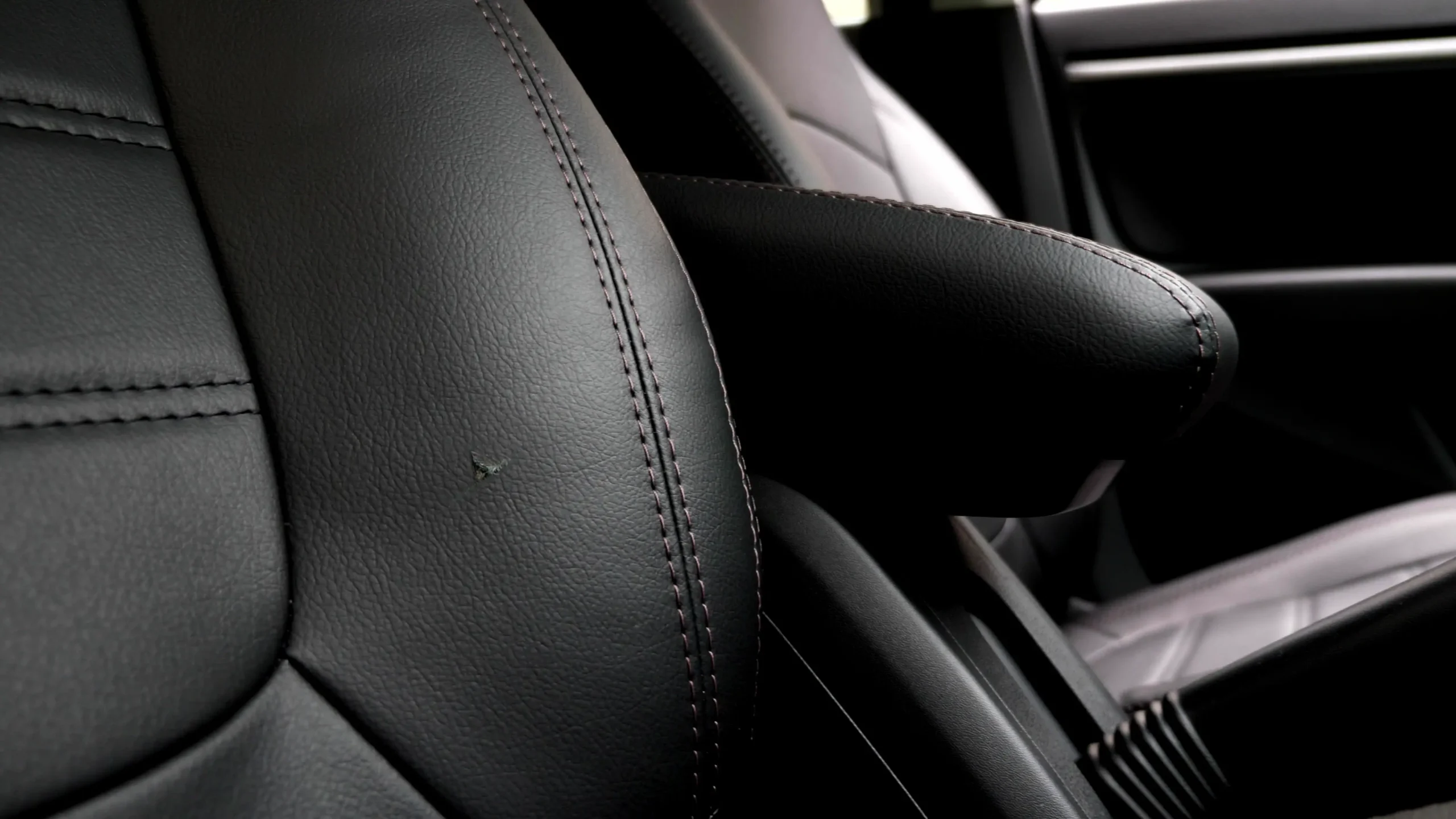 A small hole in a leather car seat