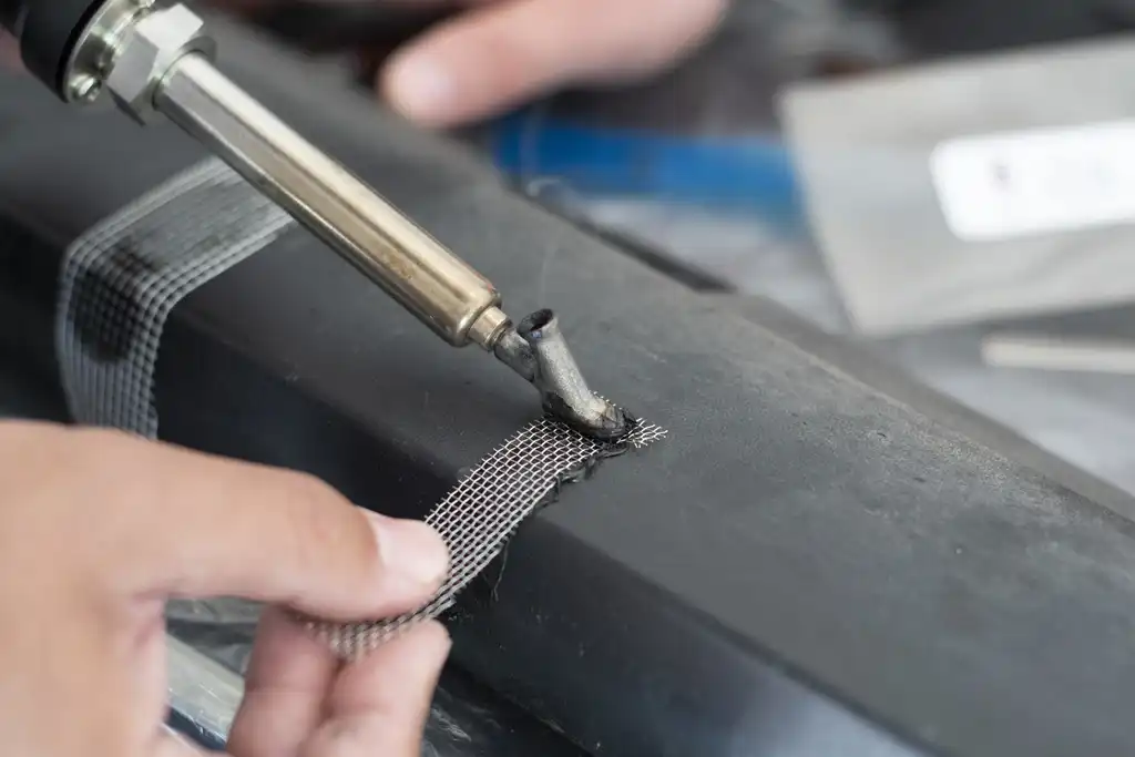 Closeup of a plastic welding process during a plastic exterior repair.