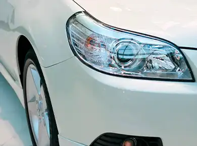 Shiny headlights on a white car
