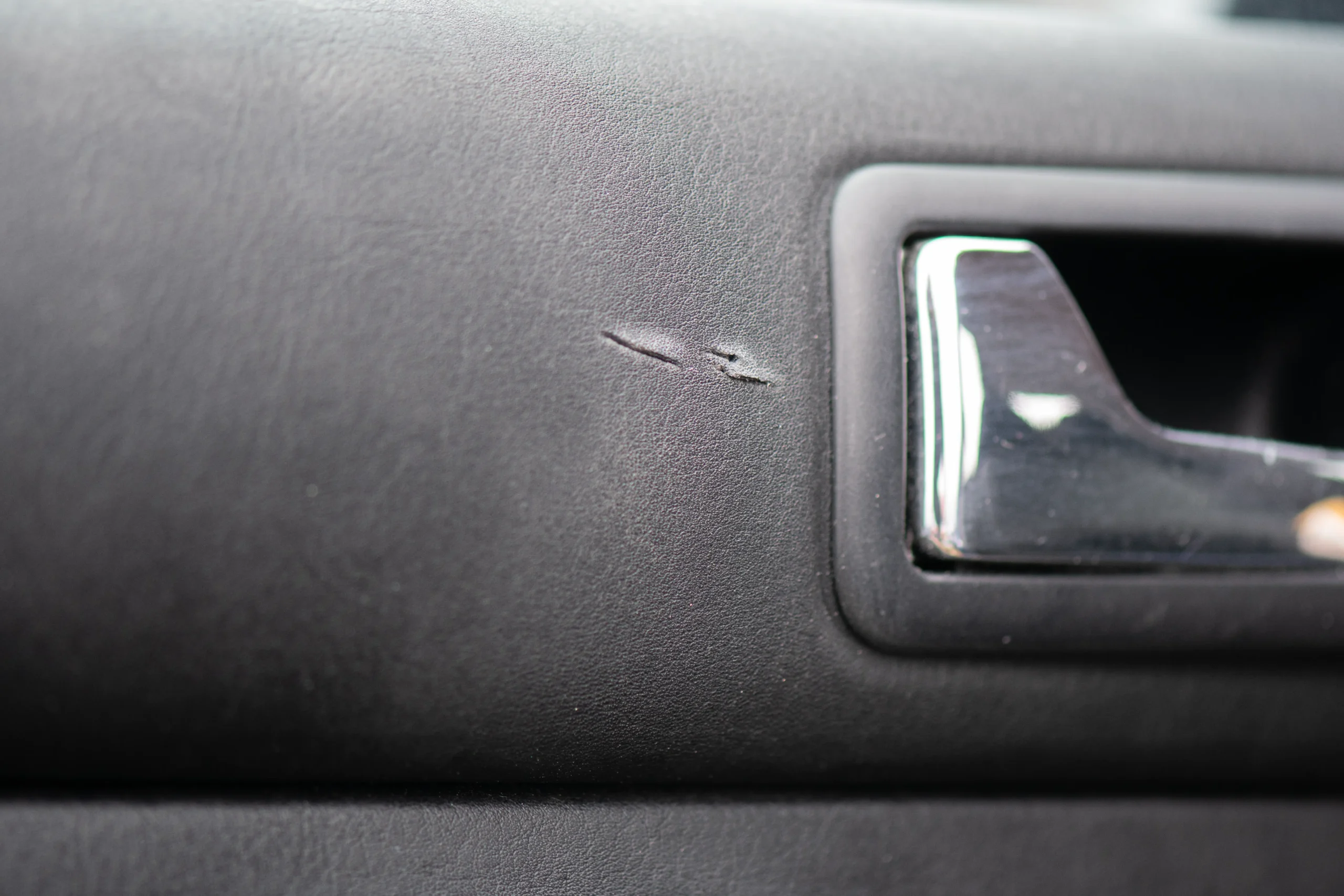 Damage to the interior of a car door in vinyl