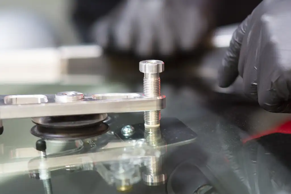 A technician restoring a stone chip in a windshield.